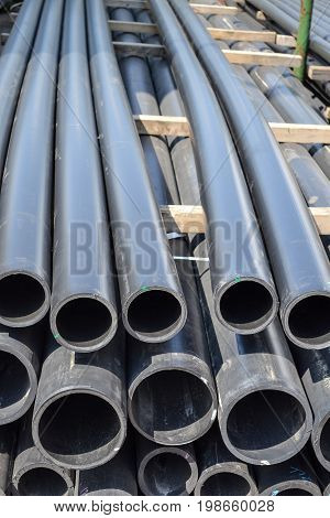 Plastic pipes in stock of finished products stacked in packs