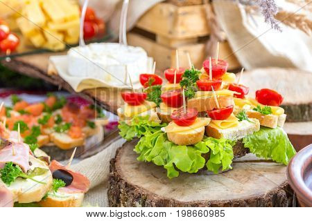 Tomatoes and cheese. Banquet feasts. Banquet table