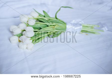 Bouquet Of Tulips On White Bed