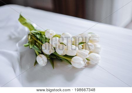 Bouquet Of Tulips On White Bed