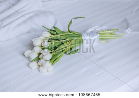 Bouquet Of Tulips On White Bed
