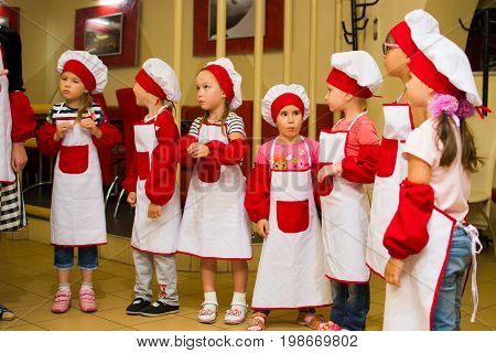 Alchevsk, Ukraine - July 30, 2017: School Cooks For Children. Learn To Cook Pasta With Sausages