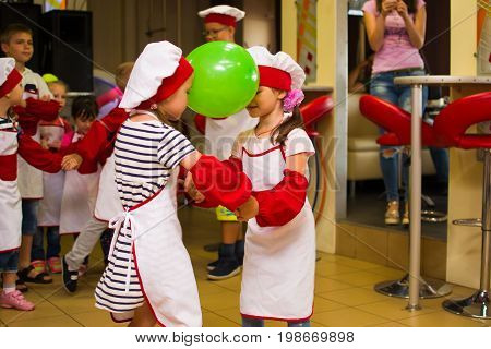 Alchevsk, Ukraine - July 30, 2017: School Cooks For Children. Learn To Cook Pasta With Sausages