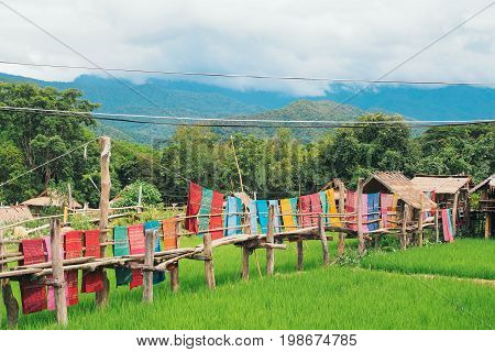 Wooden bridge and colorful cloth in the fields