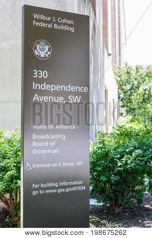 Washington DC USA - July 3 2017: Sign for Voice of America and Broadcasting Board of Governers Wilbur J. Cohen building in downtown