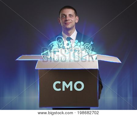 Business, Technology, Internet And Network Concept. Young Businessman Shows The Word: Cmo