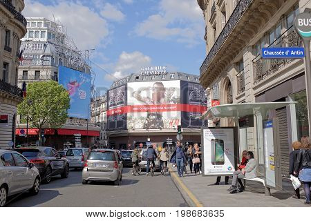 ParisFrance- April 29 2017: La Fayette shopping center view from the Boulevard Haussmann.On the street pedestrians and moving vehicles