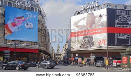 ParisFrance- April 29 2017: La Fayette shopping center view from the Boulevard Haussmann.On the street pedestrians and moving vehicles