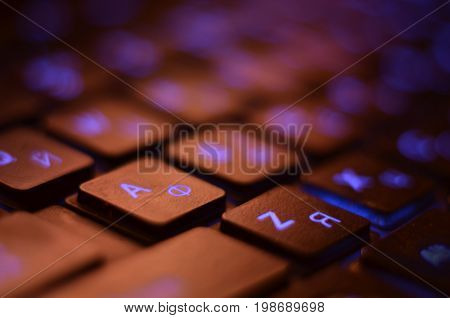 Close up. Blue backlight backlit on laptop or keyborad computer of gaming in the dark. Computer laptop keyboard with Blue dark backlight backlit in the dark. Concept computer.