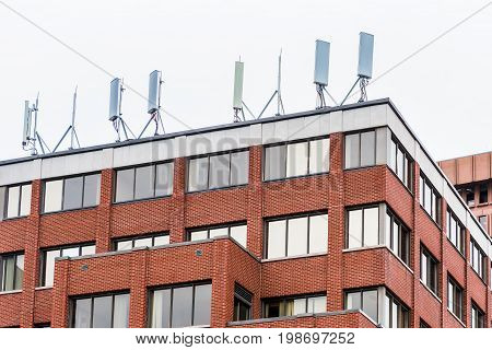 Cell phone towers on brick building in city