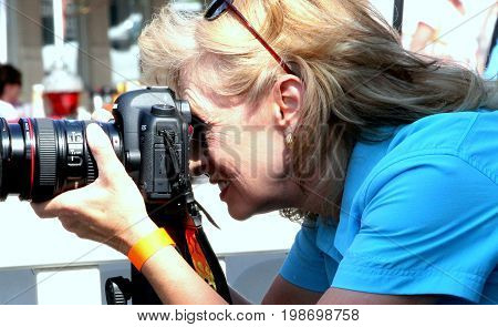 AUGUST 11, 2012. CASPER, WY: Female photographer attending a photoshoot in downtown Casper, Wy.
