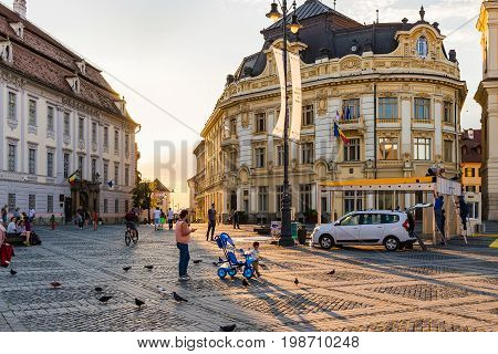 SIBIU ROMANIA - JUNE 19 2017: Large main square Huet with City Hall brukenthal museum and tourists on the street ancient medieval city.