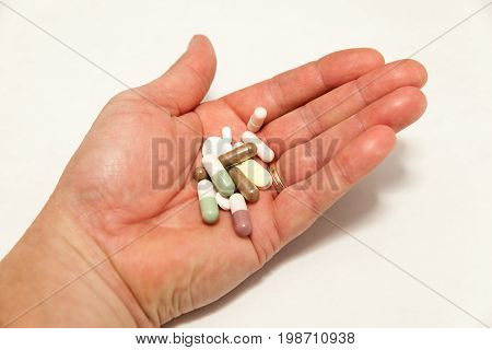 Hand Of An Adult Man With A Lot Of Cachet And Pills Symbolizing The Exce Of Drugs