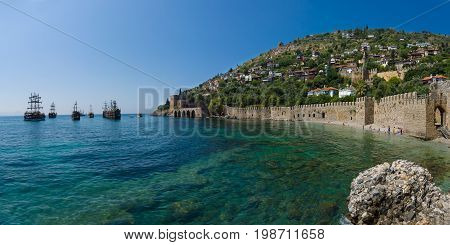 Shipyard (Tersane) and the ruins of a medieval fortress (Alanya Castle) on the mountainside. Panoramic view. Alanya. Turkey.