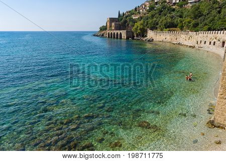 Shipyard (Tersane) and the ruins of a medieval fortress (Alanya Castle) on the mountainside. Alanya. Turkey.