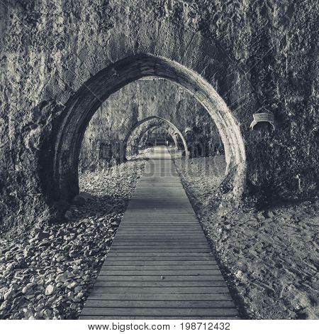 The interior of the shipyard (Tersane) in the ruins of a medieval fortress (Alanya Castle). Alanya. Turkey. Black and white. Stylization.