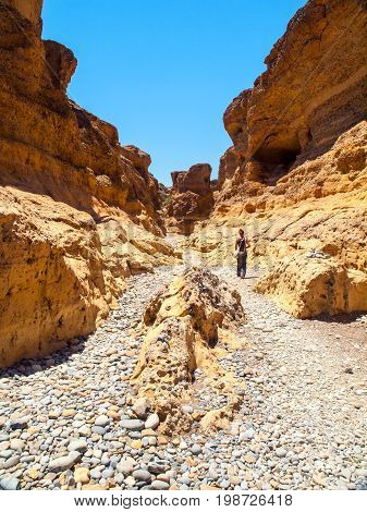 Woman hiking in Sesriem Canyon near Sossusvlei shaped by Tsauchab River, Namib Desert, Namibia