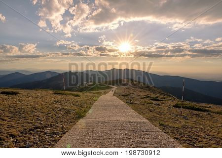 Hikers walking on a mountain at sunset in Navacerrada Madrid. Spain