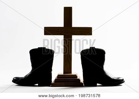 Cowboy Church with cowboy boots and Holy Cross.