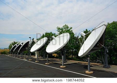 Array of Large Satellite Dishes on a Sunny Day
