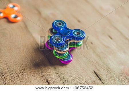 Colored Fidget Spinners Stress Relieving Toy On Wooden Background