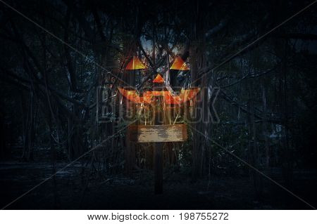 Cross with Jack O Lantern pumpkin over spooky forest at night time Horror background Halloween concept