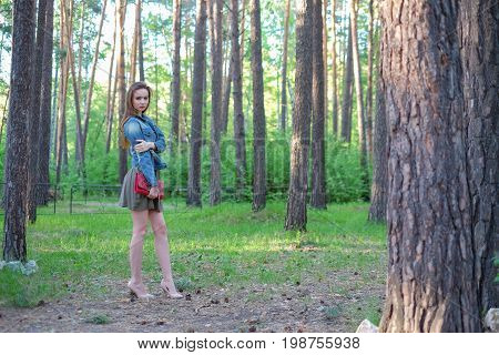 Beautiful sexy woman glamor fashion model female perfect beauty pose wear stylish clothes fall collection pants jacket accessory handbag shoes forest trees nature sun river walk in park romantic date.