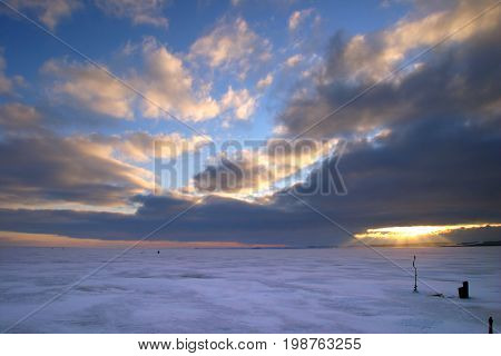 Fisherman On The River Covered With Ice