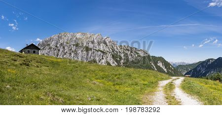 Old stone hut with mountain Gartnerkofel in the background on Nassfeld in Carnic Alps in Austria