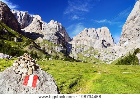 view of southern side of Marmolada with tourist sign top of Alps Dolomites mountains Dolomiti Italy