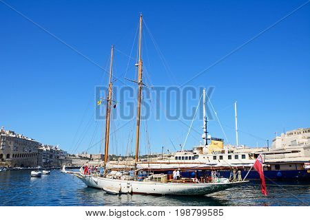 VITTORIOSA, MALTA - MARCH 31, 2017 - View of yachts moored in the marina with views towards Senglea to the left and Valletta to the rear Vittoriosa Malta Europe, March 31, 2017.