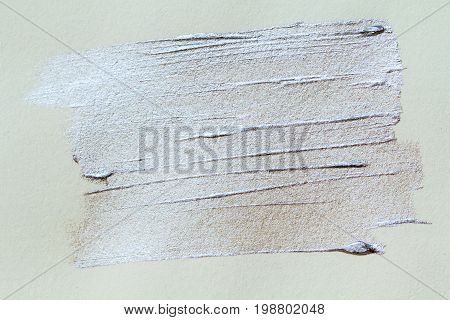 Silver paint brush stroke on white paper. Silver stroke abstract background. Shiny metallic paint closeup. Silver texture backdrop. Acrylic paint on canvas. Paintbrush stroke on paper. Abstract banner