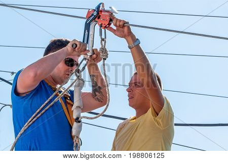Ukraine Migea - July 30 2017: Zipline. The instructor conducts the instruction on safety of the next fan of an extreme. Starting platform on a high rock. Extreme and active rest.