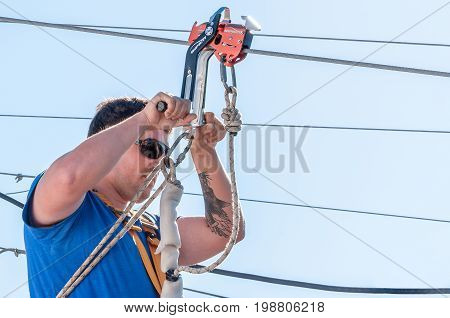 Ukraine Migea - July 30 2017: Zipline. The instructor conducts the instruction on safety of the next fan of an extreme. Starting platform on a high rock. Extreme and active rest.