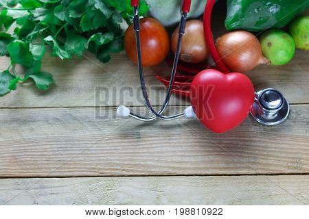 Healthy hearth concept ear doctor with herb leaf and vetgetable on wood background