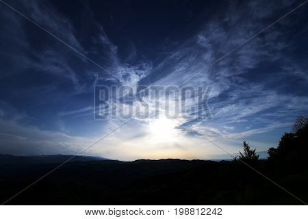 Dark Blue Sky. Sunset sky background. Dramatic sunset sky with evening sky clouds lit by bright sunligh
