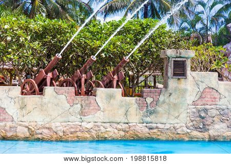 rows of water cannons shooting out water into the pool at a water park in Thailand