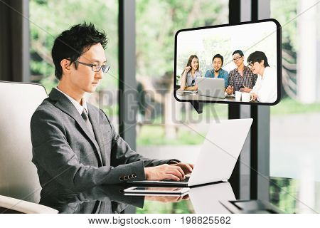 Young Asian businessman CEO entrepreneur VDO conference call with diverse business partner group or employee. Company leader remote live online meeting or financial invest funding advisor concept