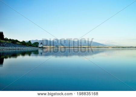View on level water in dam Liptovska Mara with the background of the Havranok church. Water reservoir on Liptov.