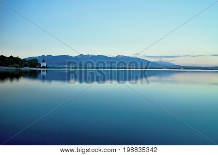 View on level water in dam Liptovska Mara with the background of the Havranok church.