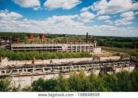 Aerial panoramic view of big abandoned industrial factory or plant area, Overgrown with wood, ruined buildings, industrial landscape