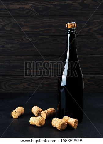 Wine Bottle On Wood Floor And Grunge Background, Nearby Cork, Tinsel, The Concept Of The Celebration