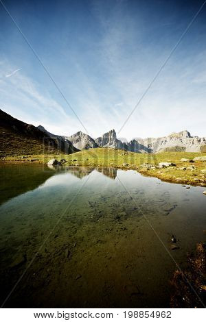 Peaks reflected in Ansabere Lake. Lescun Cirque. Aspe Valley, Pyrenees, France.