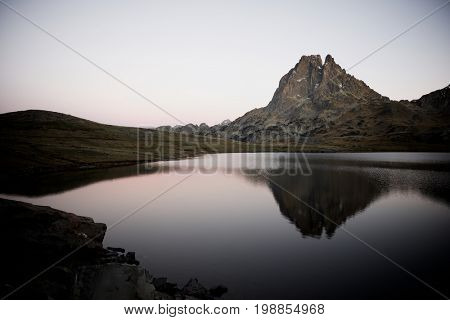 Midi Dossau Peak reflected in Ayous lake. Ossau Valley, Pyrenees National Park, Pyrenees, France.