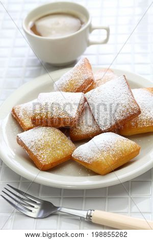 homemade new orleans beignet donuts and a cup of coffee