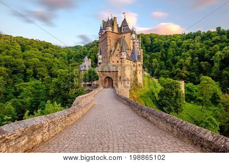 Burg Eltz castle in Rhineland-Palatinate state at sunset, Germany. Construction started	prior to 1157.