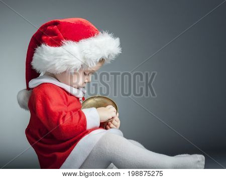 portrait of cute female caucasian child with santa claus clothes