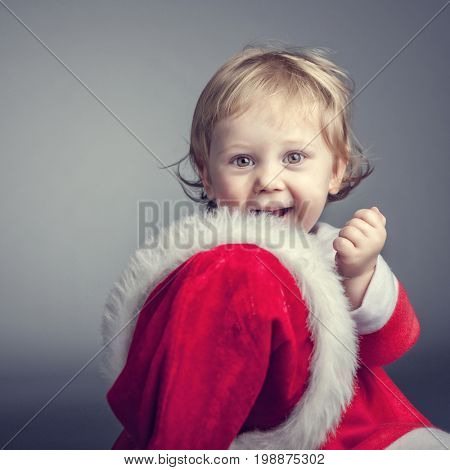 portrait of cute female caucasian child with santa claus clothes