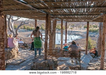 ETOSHA NATIONAL PARK NAMIBIA - JUNE 21 2017: Unidentified tourists at the Moringa Waterhole at Halali in the Etosha National Park Namibia