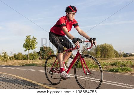 Cycling Concepts and Ideas. Male Caucasian Road Cyclist During Ride on Bike Outdoors. Completely Equipped in Professional Outfit.Horizontal Image Composition